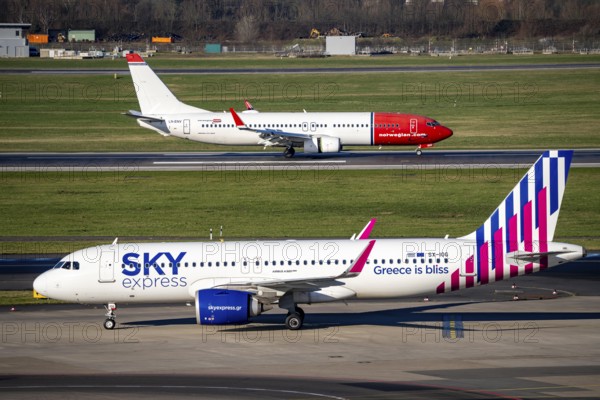 Sky Express Airbus A320 and Norwegian Boeing 737, aircraft after landing at Düsseldorf Airport, main runway 05R/23L, South, DUS, North Rhine-Westphalia, Germany, Europe