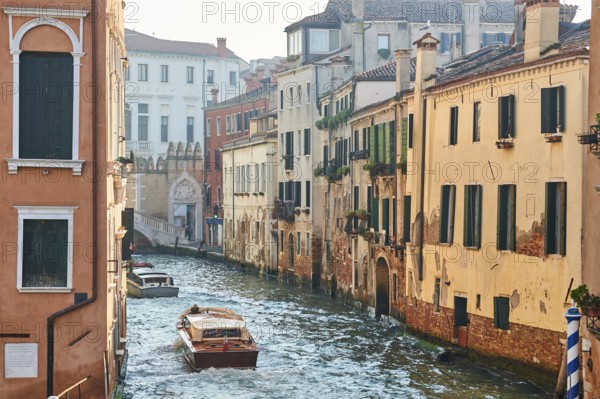 View on a waterway with boats in the water in Venice on a sunny day in winter, Italy, Europe