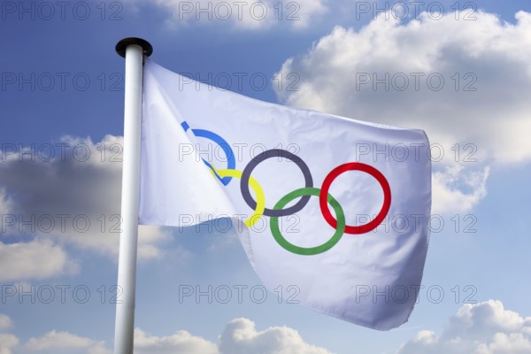 Olympic flag in front of a blue sky