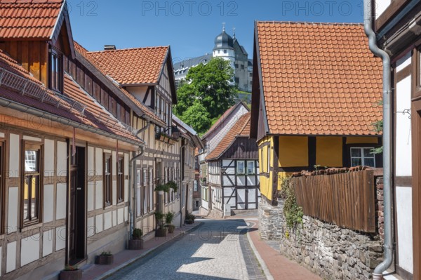 Street with half-timbered houses and cobblestones in the historic old town, behind the castle, Stolberg im Harz, Saxony-Anhalt, Germany, Europe