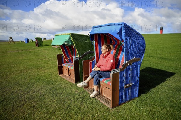 Woman in a beach chair on the island of Pellworm, Wadden Sea National Park, North Frisia, Germany, Europe