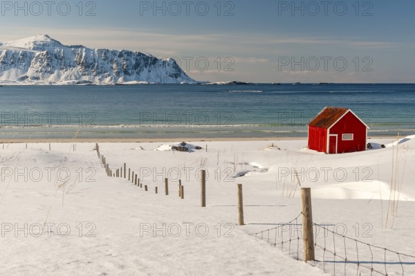 Red hut, snowy landscape, sea, mountains, Lofoten, Northern Norway, Norway, Europe