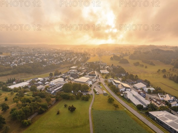 Light-flooded industrial site near a village at sunrise, Gechingen, Black Forest, Germany, Europe