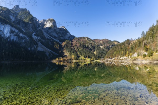 The Vordere Gosausee in autumn with a view of the Gasthof Gosausee. The Gosaukamm on the left, good weather, blue sky. Reflection. Vorderer Gosausee, Gosau, Gosau valley, Salzkammergut, Upper Austria, Austria, Europe