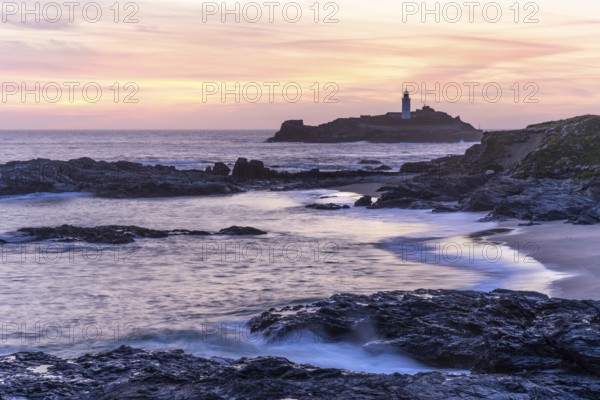 Godrevy Lighthouse, the lighthouse of Godrevy on Godrevy Island. In the evening at sunset. Long exposure. Cornwall, England, Great Britain