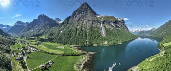 Aerial panoramic view over fjord Hjorundfjord, village Oye with Union hotel (left), marina, mt. Stalbergneset, Norway, Europe