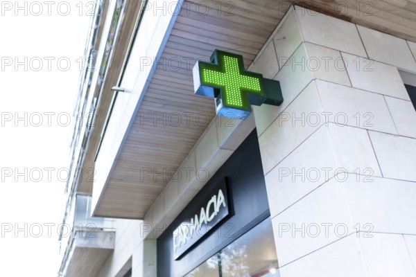 Pharmacy Neon Green Cross Sign on a building