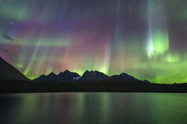 Northern lights over Bergen in the Lyngen Alps, reflection on the lake, Troms og Finnmark, Norway, Europe