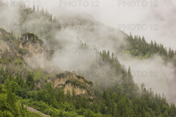 Wisps of mist cover the Karwendel mountains in the Großer Ahornboden nature reserve, Eng Valley, Tyrol, Austria, Europe