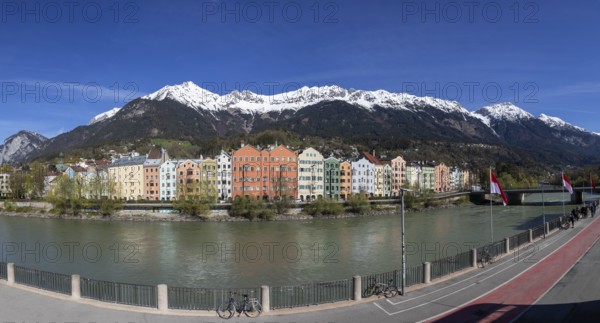 Colourful buildings along the Inn river with snow-covered Nordkette in the background, Karwendel mountains, Innsbruck, Tyrol, Austria, Europe