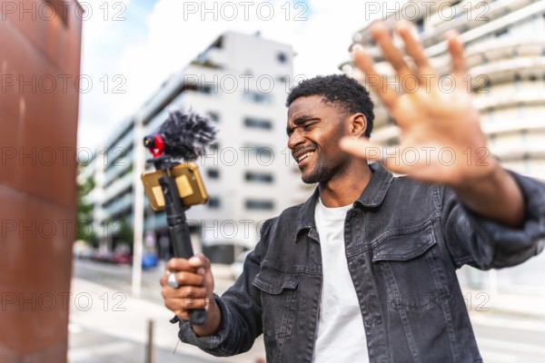 Cool streamer african man recording video blog in the city