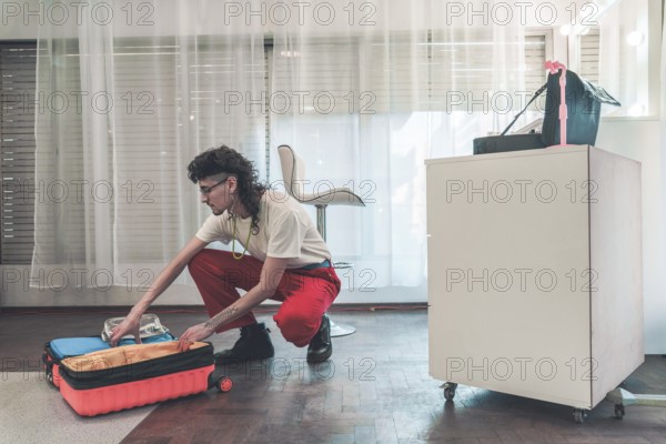 Young non-binary individual with a mullet haircut organizing beauty products in a trolley case, highlighting diversity and inclusion in the beauty industry