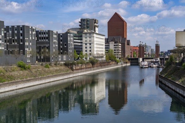 The Schwanentor Bridge in the inner harbour of Duisburg, one of 3 lifting bridges, can be raised up to 10 metres, freshly renovated, connects the city centre with the district of Kaßlerfeld, Ruhrort, tower of the former RWSG warehouse, today the seat of the State Archives of North Rhine-Westphalia, on the left the building of the LZPD, Germany, Europe
