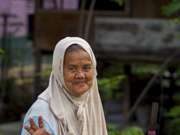 Old muslim woman, laughing with stick, Sulawesi, Indonesia, Asia