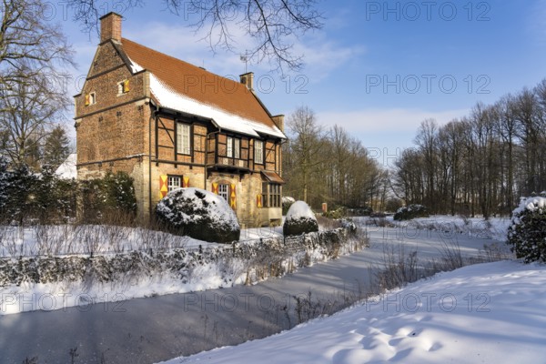 The snow-covered moated castle Haus Bisping in winter, Drensteinfurt, Münsterland, North Rhine-Westphalia, Germany, Europe