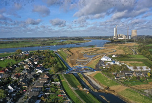 Dinslaken, Voerde, North Rhine-Westphalia, Germany, Inauguration of the new Emscher estuary into the Rhine. The decommissioned STEAG Voerde coal-fired power station is in the background. The mouth of the Emscher into the Rhine has been moved almost 500 metres north from Dinslaken to Voerde. Fish can now swim barrier-free up the new Emscher from the Rhine through a newly created floodplain area. Following the construction of a parallel sewer, the Emscher has been completely free of sewage since January 2022. The river was previously an open, above-ground combined sewer with rainwater and wastewater, Europe
