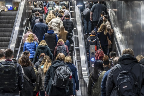 Public transport, underground, main station exit, many people crowding out of the underground station at rush hour in the afternoon, via stairs and escalators, North Rhine-Westphalia, Germany, Europe