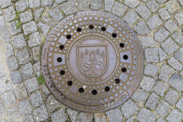 Manhole cover with coat of arms in Beeskow, Brandenburg, Germany, Europe