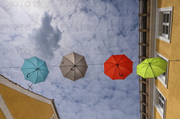 Colourful umbrellas stretched across the street, promising a prosperous and perfect life, Schärding, Lower Austria, Austria, Europe