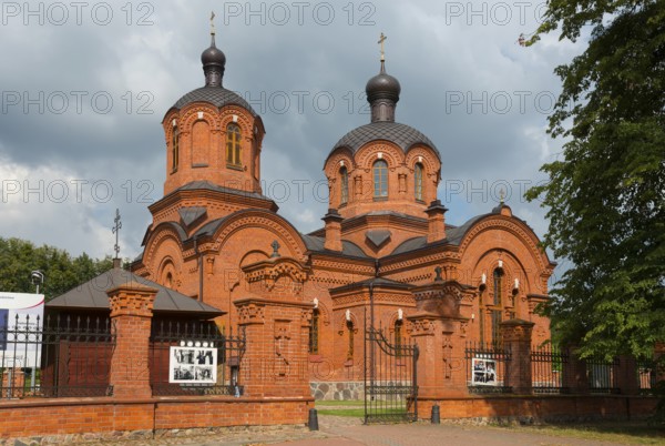 Orthodox church with two red-brick domes, enveloped in dramatic clouds, Orthodox Church of St Nicholas, Bialowieza, Bialowieza, Podlaskie Voivodeship, Podlasie, Poland, Europe