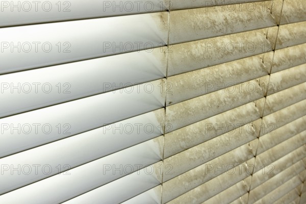 Residential window shades showing the before and after of a good cleaning, one side clean and one side dirty