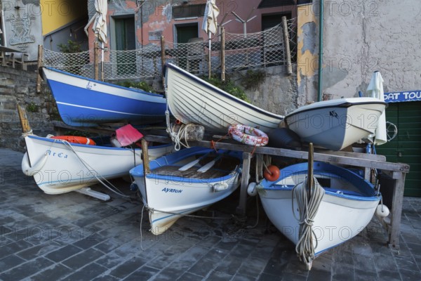 Close-up of stored white and blue traditional fishing boats on dry land, Riomaggiore, Cinque Terre, La Spezia, Italy, Europe