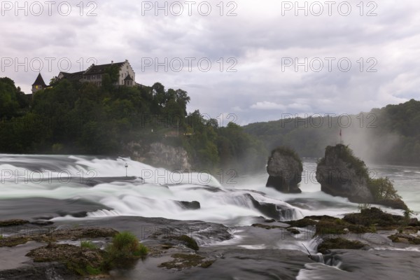 Majestic waterfall with castle in the background, Schloss Laufen, Rhine Falls, Canton Schaffhausen, Switzerland, Europe