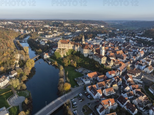 Aerial view of the town of Sigmaringen with the Hohenzollern Castle, a sight and tourist attraction above the old town and the Danube with autumnal vegetation, Danube valley, district of Sigmaringen, Baden-Württemberg, Germany, Europe