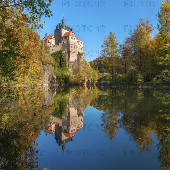 Kriebstein Castle near Mittweida surrounded by colourful forest in autumn, reflection in the river Zschopau, Kriebstein, Saxony, Germany, Europe