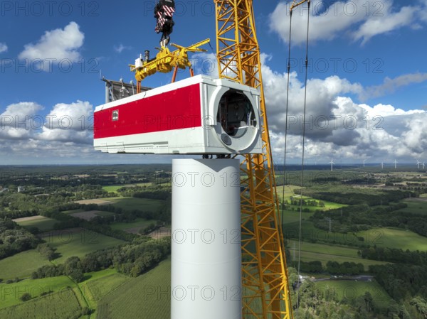Dorsten, North Rhine-Westphalia, Germany, construction of a wind turbine, the first wind turbine of the Große Heide wind farm. A large mobile crane places the nacelle, the nacelle on the tower, Europe
