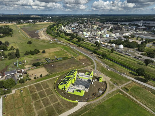 Oberhausen, North Rhine-Westphalia, Germany, renaturalisation of the Emscher in the Holtener Bruch. In front, the new Oberhausen pumping station. OQ Chemicals plant Ruhrchemie on the right. The Emscher, currently straightened, has been given curves again and can meander through its new floodplain. The ecological conversion of the Emscher system consists of the construction of a centralised wastewater treatment system in the Ruhr region, the construction of sewers and the renaturation of the Emscher and its tributaries. Following the construction of a parallel sewer, the Emscher has been completely free of sewage since January 2022. The river was previously an open, above-ground combined sewer with rainwater and wastewater, Europe