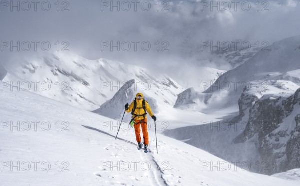 Ski tourers climbing the Wildhorn, Snowy mountain landscape and fog, Bernese Alps, Bernese Oberland, Switzerland, Europe
