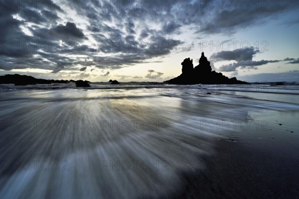 Dramatic clouds with rock formation at rising tide at the beach of Playa de Benijo, Tenerife, Canary Island, Spain, Europe