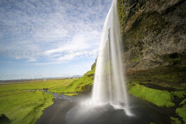 Seljalandsfoss waterfall with rainbow, long exposure, Seljalandsa river, South Iceland, Iceland, Europe