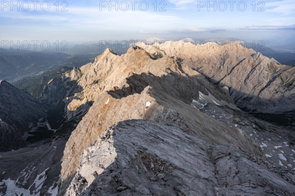 Impressive rocky mountain landscape in the evening light, steep mountain ridge, Jubiläumsgrat with Alpspitze, Zugspitze, Wetterstein range, Bavaria, Germany, Europe