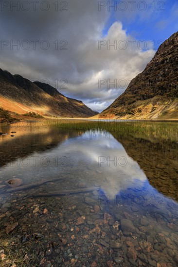 Mountains reflected in lake, evening light, cloudy mood, autumn, Loch Achtriochtan, Glencoe, Scottish Highlands, Scotland, Great Britain