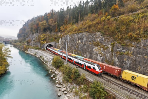 Train of the S-Bahn Vorarlberg and goods train of the Austrian Federal Railways ÖBB Eisenbahn in autumn in Feldkirch, Austria, Europe