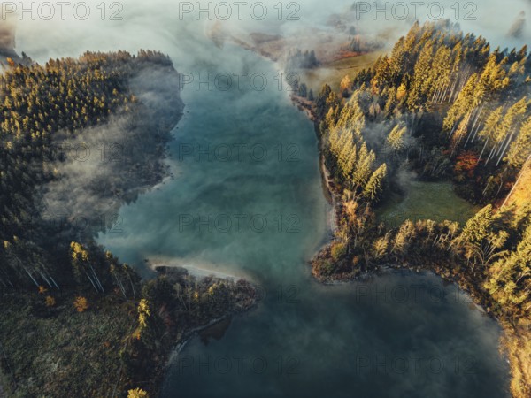 Autumn sunrise in the foothills of the Alps with fog at Illasbergsee and Forggensee near Halblech in Allgäu, Bavaria, Germany, Europe