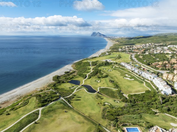 The La Hacienda Links Golf Resort at the Mediterranean Sea with the Rock of Gibraltar (British) in the distance. Aerial view. Drone shot. Cádiz province, Andalusia, Spain, Europe