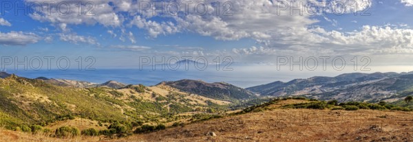 Panorama of a wide hilly landscape with a view of the sea, near Tarifa, view to Morocco