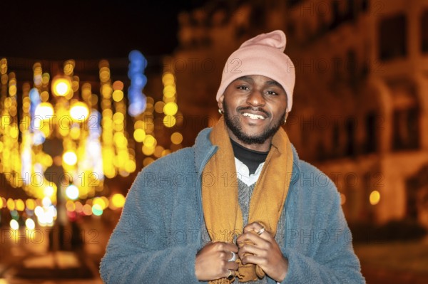 Portrait of an african man smiling in the city at Christmas night