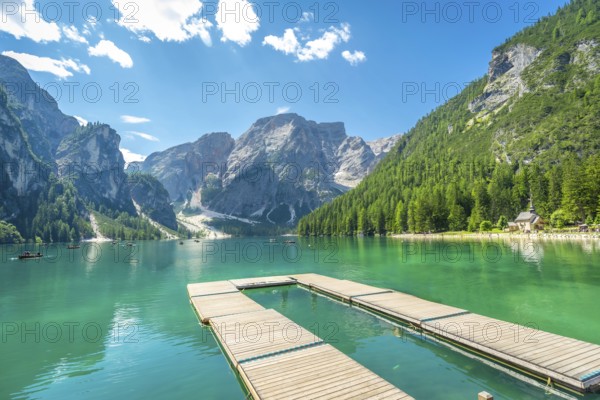 Breathtaking landscape with emerald green water and majestic peaks in the italian dolomites, perfect for summer vacations