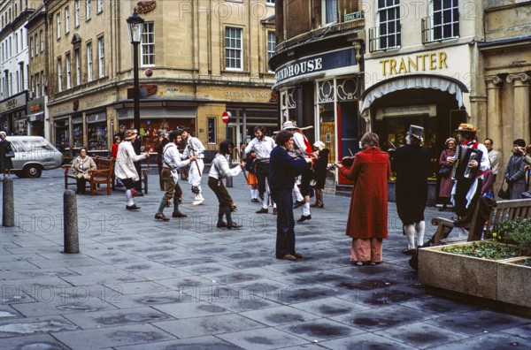 Morris dancers performing in Stall Street, Bath, Somerset, England, UK 1976 in front of the Tranter tobacconist and The Roundhouse pub