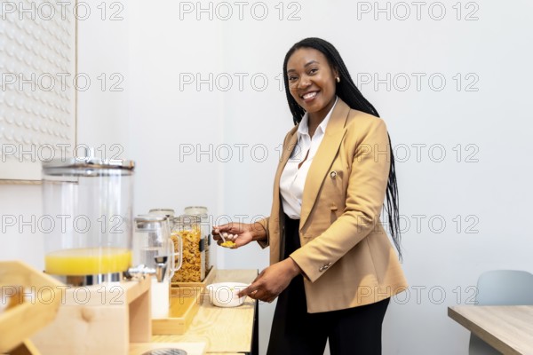 Businesswoman serving herself some cereal at the hotel breakfast buffet during her business trip, enjoying a healthy breakfast before starting her workday