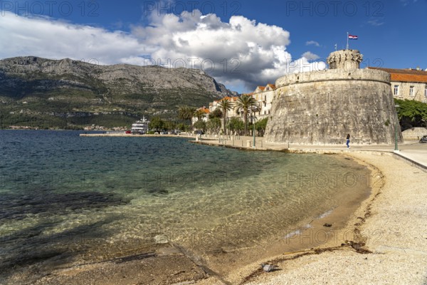 Luka Korculanska beach and the large prince's tower and the old town centre of Korcula, Croatia, Europe