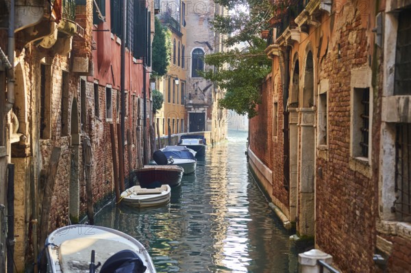 View on a waterway with boats lying in the water in Venice on a sunny day in winter, Italy, Europe
