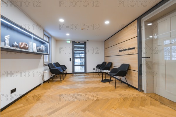 Modern waiting room with seating, wooden wall and decorative shelf, Nagold Town Hall, Black Forest, Germany, Europe