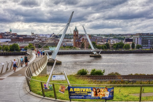 City view with a striking bridge in the foreground and a dense cloud backdrop, Londonderry