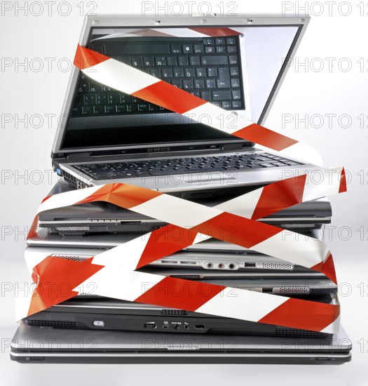 Pile of discarded notebooks, wrapped with barrier tape, disposal issue