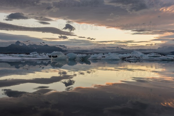 Icebergs at sunset, reflection, Jökulsárlón glacier lagoon or Jökulsarlon, South Iceland, Iceland, Europe